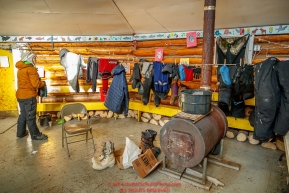 Katherine Keith puts up some of her clothes to dry over a wood stove in the community center at the Kaltag checkpoint during the 2017 Iditarod on Sunday evening  March 12, 2017.Photo by Jeff Schultz/SchultzPhoto.com  (C) 2017  ALL RIGHTS RESERVED