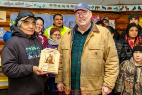 Richard Burnham, on behalf of the entire family accepts the Herbie Nayokupuk Spirit of Iditarod for his father-in-law Austin Esmailka, from race judge Kevin Sakai at the Kaltag checkpoint during the 2017 Iditarod on Sunday morning March 12, 2017.Photo by Jeff Schultz/SchultzPhoto.com  (C) 2017  ALL RIGHTS RESERVED