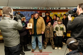 Richard Burnham, on behalf of the entire family accepts the Herbie Nayokupuk Spirit of Iditarod award for his father-in-law Austin Esmailka, from race judge Kevin Sakai at the Kaltag checkpoint during the 2017 Iditarod on Sunday morning March 12, 2017.Photo by Jeff Schultz/SchultzPhoto.com  (C) 2017  ALL RIGHTS RESERVED