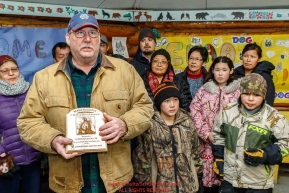 Richard Burnham, on behalf of the entire family accepts the Herbie Nayokupuk Spirit of Iditarod for his father-in-law Austin Esmailka at the Kaltag checkpoint during the 2017 Iditarod on Sunday morning March 12, 2017.Photo by Jeff Schultz/SchultzPhoto.com  (C) 2017  ALL RIGHTS RESERVED
