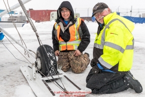 Pilots Daniel Hayden and Jerry Wortley work on his wheel-skis during a weather hold at the Unalakleet checkpoint on Monday  morning March 12th during the 2018 Iditarod Sled Dog Race -- AlaskaPhoto by Jeff Schultz/SchultzPhoto.com  (C) 2018  ALL RIGHTS RESERVED