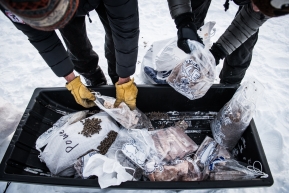 Cripple checkpoint volunteers sorting through left over food from mushers drop bags.