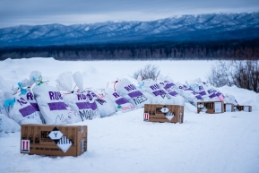 Musher bags and fuel are arranged on the bluffs above the Yukon River in Ruby, Alaska.