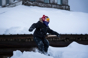It's spring break in Alaska and a local elementary student enjoys playing in the snow at the checkpoint.
