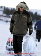 Tuesday March 13, 2012  Race Judge Andy Anderson drags musher food drop bags to them at White Mountain. Iditarod 2012.