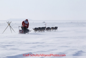 Tuesday March 13, 2012 Dallas Seavey in 25 mph winds on the sea ice just prior to arriving in Nome. Iditarod 2012.