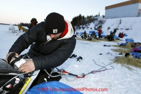 Tuesday March 13, 2012  Ion Earth employee Jimmy Anderson replaces Aaron Burmeister 's GPS tracking device with a working one at the White Mountain checkpoint. Iditarod 2012.