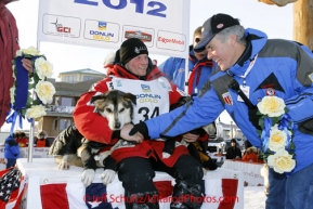 Tuesday March 13, 2012  Dallas Seavey 's lead dogs are presented the roses shorlty after Dallas won the 2012 Iditarod Nome from ExxonMobil representative Dale Pittman. Iditarod 2012.