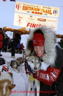 Tuesday March 13, 2012   Aliy Zirkle's lead dog Quito aka "no quit-o" is hugged by Aliy shortly after she arrived in second place at the finish line in Nome. Iditarod 2012.