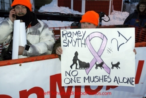 Tuesday March 13, 2012   Third place finisher Ramey Smyth has a fan at the finish line in Nome.  Iditarod 2012.