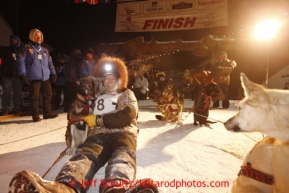 Jeff King lies with his lead dog Skeeter in the finish chute after finishing in 3rd place in Nome on Wednesday March 13, 2013.Iditarod Sled Dog Race 2013Photo by Jeff Schultz copyright 2013 DO NOT REPRODUCE WITHOUT PERMISSION