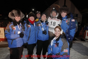 Jeff King poses at the finish line in Nome with representatives from race sponsor ExxonMobil after finishing in 3rd place on Wednesday March 13, 2013.Iditarod Sled Dog Race 2013Photo by Jeff Schultz copyright 2013 DO NOT REPRODUCE WITHOUT PERMISSION