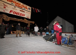 Ray Redington Jr. runs down the finish chute in Nome to place fifth on Wednesday March 13, 2013. Iditarod Sled Dog Race 2013Photo by Jeff Schultz copyright 2013 DO NOT REPRODUCE WITHOUT PERMISSION