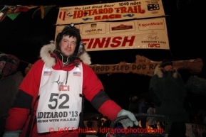 Ray Redington Jr. poses at the finsh line in Nome on Wednesday March 13, 2013 after finishing in fifth place. Iditarod Sled Dog Race 2013Photo by Jeff Schultz copyright 2013