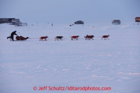 Paul Gebhart runs on the trail past Farley's camp several miles before the finish line in Nome on Wednesday March 13, 2013. Iditarod Sled Dog Race 2013Photo by Jeff Schultz copyright 2013 DO NOT REPRODUCE WITHOUT PERMISSION