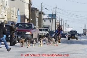 Michelle Phillips runs down Front Street on her way to the finish chute in Nome on Wednesday March 13, 2013. Iditarod Sled Dog Race 2013Photo by Jeff Schultz copyright 2013 DO NOT REPRODUCE WITHOUT PERMISSION