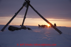 Paul Gebhart runs on the trail past a tripod trail marker at sunrise several miles before the finish line in Nome on Wednesday March 13, 2013. Iditarod Sled Dog Race 2013Photo by Jeff Schultz copyright 2013 DO NOT REPRODUCE WITHOUT PERMISSION