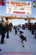 Jessica Hendricks runs down the chute to cross the finish line in Nome on Wednesday March 13, 2013. Iditarod Sled Dog Race 2013Photo by Jeff Schultz copyright 2013 DO NOT REPRODUCE WITHOUT PERMISSION