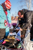 Aaron Burmeister signs autographs for young race fans in the afternoon at the Huslia checkpoint on Friday March 13, 2015 during Iditarod 2015.  (C) Jeff Schultz/SchultzPhoto.com - ALL RIGHTS RESERVED DUPLICATION  PROHIBITED  WITHOUT  PERMISSION