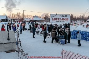 Jessie Royer is greeted by a crowd as she arrives in the evening at the Huslia checkpoint on Friday March 13, 2015 during Iditarod 2015.  (C) Jeff Schultz/SchultzPhoto.com - ALL RIGHTS RESERVED DUPLICATION  PROHIBITED  WITHOUT  PERMISSION