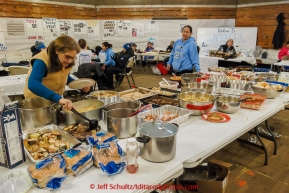 There is a full spread of food available for anyone and everyone at inside the Community hall at the Huslia checkpoint on Friday March 13, 2015 during Iditarod 2015.  (C) Jeff Schultz/SchultzPhoto.com - ALL RIGHTS RESERVED DUPLICATION  PROHIBITED  WITHOUT  PERMISSION