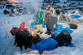 Voliunteer vets, Bill Sampson, Steve Shipley, and Vic Vukich  take warmth around a campfire at 30 below zero as they wait on teams in the morning at the Galena checkpoint on Friday March 13, 2015 during Iditarod 2015.  (C) Jeff Schultz/SchultzPhoto.com - ALL RIGHTS RESERVED DUPLICATION  PROHIBITED  WITHOUT  PERMISSION