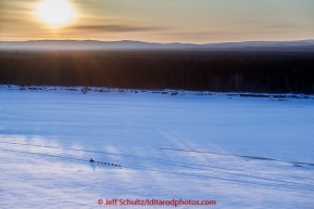 A team runs down the Yukon River as the sun rises near the  Galena checkpoint on Friday March 13, 2015 during Iditarod 2015.  (C) Jeff Schultz/SchultzPhoto.com - ALL RIGHTS RESERVED DUPLICATION  PROHIBITED  WITHOUT  PERMISSION