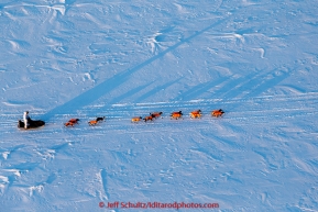 Alan Stevens team casts long shadows on the Yukon River at sunrise on his way into the Galena checkpoint on Friday March 13, 2015 during Iditarod 2015.  (C) Jeff Schultz/SchultzPhoto.com - ALL RIGHTS RESERVED DUPLICATION  PROHIBITED  WITHOUT  PERMISSION