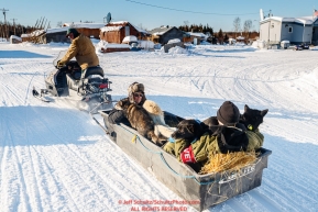 Long time volunteer Rich Burnham takes two vets and a load of dropped dogs to the airport via snowmachine at the Kaltag checkpoint during the 2017 Iditarod on Monday morning March 12, 2017.Photo by Jeff Schultz/SchultzPhoto.com  (C) 2017  ALL RIGHTS RESERVED