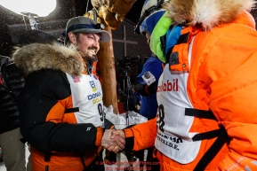 First place winner Pete Kaiser congratulates second place finisher Joar Leifseth Ulsom at the Nome finish line shortly after winning the 2019 Iditarod Trail Sled Dog Race. Pete's winning time is 9 days 12 hours 39 minutes and 6 secondsPhoto by Jeff Schultz/  (C) 2019  ALL RIGHTS RESERVED