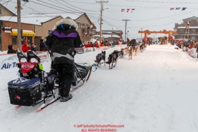 Jessie Royer runs down the finish chute as she makes her way toward the Nome finish line to place 3rd in the 2019 Iditarod sled dog race.Photo by Jeff Schultz/  (C) 2019  ALL RIGHTS RESERVED