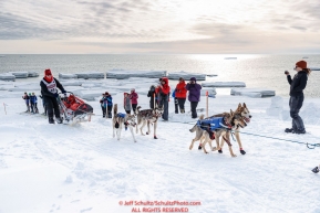 Aliy Zirkle runs off of the Bering Sea ice near Nome with open water and icebergs in the background with a crowd of spectators cheering her on as she heads to a 4th place finish of the 2019 Iditarod on Wednesday March 13Photo by Jeff Schultz/  (C) 2019  ALL RIGHTS RESERVED