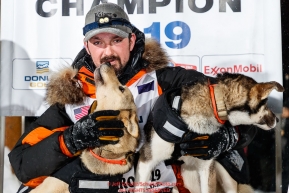 Pete Kaiser poses with his Marrow (L) and Lucy at the Nome finish line after winning the 2019 Iditarod Trail Sled Dog Race. Pete's winning time is 9 days 12 hours 39 minutes and 6 secondsPhoto by Jeff Schultz/  (C) 2019  ALL RIGHTS RESERVED