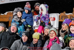 Pete Kaiser and family pose with friends and family from Bethel, Alaska at the Nome finish line after Pete wins the 2019 Iditarod Trail Sled Dog Race. Pete's winning time is 9 days 12 hours 39 minutes and 6 secondsPhoto by Jeff Schultz/  (C) 2019  ALL RIGHTS RESERVED