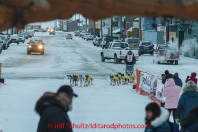 Mats Pettersson runs into the chute toward the burl arch finish line in Nome on Thursday March 13 during the 2014 Iditarod Sled Dog Race.PHOTO (c) BY JEFF SCHULTZ/IditarodPhotos.com -- REPRODUCTION PROHIBITED WITHOUT PERMISSION