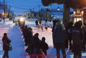 Allen Moore runs into the chute toward the burl arch finish line in Nome on Thursday March 13 during the 2014 Iditarod Sled Dog Race.PHOTO (c) BY JEFF SCHULTZ/IditarodPhotos.com -- REPRODUCTION PROHIBITED WITHOUT PERMISSION