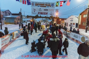 Allen Moore and his friends in the finish chute under the burl arch in Nome on Thursday March 13 during the 2014 Iditarod Sled Dog Race.PHOTO (c) BY JEFF SCHULTZ/IditarodPhotos.com -- REPRODUCTION PROHIBITED WITHOUT PERMISSION
