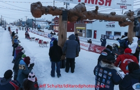 Paul Gebhart runs into the chute toward the burl arch finish line in Nome on Thursday March 13 during the 2014 Iditarod Sled Dog Race.PHOTO (c) BY JEFF SCHULTZ/IditarodPhotos.com -- REPRODUCTION PROHIBITED WITHOUT PERMISSION
