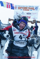 Mats Pettersson poses with his lead dogs Mikey and Jill at the burl arch finish line in Nome on Thursday March 13 during the 2014 Iditarod Sled Dog Race.PHOTO (c) BY JEFF SCHULTZ/IditarodPhotos.com -- REPRODUCTION PROHIBITED WITHOUT PERMISSION