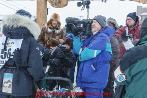 Photographers and friends crowd around Kristi Berington shortly after her arrival under the burl arch finish line in Nome on Thursday March 13 during the 2014 Iditarod Sled Dog Race.PHOTO (c) BY JEFF SCHULTZ/IditarodPhotos.com -- REPRODUCTION PROHIBITED WITHOUT PERMISSION