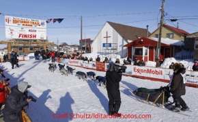 Wednesday March 14, 2012   Sonny Lindner crosses the finish line in Nome in 14th place on Wednesday morning. Iditarod 2012.