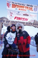 Second place finisher Aliy Zirkle, right, poses with her husband Allen Moore at the finish line shorlty after Allen finished in 33rd place  on Thursday March 14, 2013. Iditarod Sled Dog Race 2013Photo by Jeff Schultz copyright 2013 DO NOT REPRODUCE WITHOUT PERMISSION