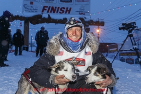 Charlie Benja poses with his lead dogs Hawk and Duke at the Nome finish chute Friday March 14 during the 2014 Iditarod Sled Dog Race.PHOTO (c) BY JEFF SCHULTZ/IditarodPhotos.com -- REPRODUCTION PROHIBITED WITHOUT PERMISSION
