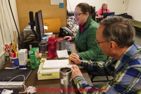 Nome Comms Jerry Trotten and Lindsey Vaughan man the phones and computer in the back room in Nome on Friday March 14 during the 2014 Iditarod Sled Dog Race.PHOTO (c) BY JEFF SCHULTZ/IditarodPhotos.com -- REPRODUCTION PROHIBITED WITHOUT PERMISSION