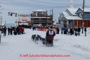 Bob Bundtzen runs up and into the finish chute in Nome on Friday March 14 during the 2014 Iditarod Sled Dog Race.PHOTO (c) BY JEFF SCHULTZ/IditarodPhotos.com -- REPRODUCTION PROHIBITED WITHOUT PERMISSION