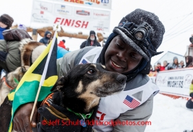 Newton Marshall poses with his lead dog in the finish chute after arriving in 43rd place in Nome on Friday March 14 during the 2014 Iditarod Sled Dog Race.PHOTO (c) BY JEFF SCHULTZ/IditarodPhotos.com -- REPRODUCTION PROHIBITED WITHOUT PERMISSION
