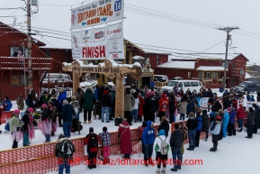 A crowd gathers around Newton Marshall and team in the finish chute after he arrived in 43rd place in Nome on Friday March 14 during the 2014 Iditarod Sled Dog Race.PHOTO (c) BY JEFF SCHULTZ/IditarodPhotos.com -- REPRODUCTION PROHIBITED WITHOUT PERMISSION