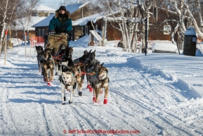 Jodi Bailey runs down the street as she leaves the Huslia checkpoint on Saturday  March 14, 2015 during Iditarod 2015.  (C) Jeff Schultz/SchultzPhoto.com - ALL RIGHTS RESERVED DUPLICATION  PROHIBITED  WITHOUT  PERMISSION