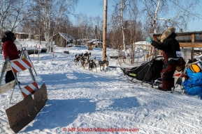 Richie Diehl waves goodbye to Doreen David of Huslia as he leaves the Huslia checkpoint on Saturday  March 14, 2015 during Iditarod 2015.  (C) Jeff Schultz/SchultzPhoto.com - ALL RIGHTS RESERVED DUPLICATION  PROHIBITED  WITHOUT  PERMISSION