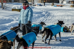 Volunteer Sally Hamm holds a team checking in during the afternoon at the Huslia checkpoint on Saturday  March 14, 2015 during Iditarod 2015.  (C) Jeff Schultz/SchultzPhoto.com - ALL RIGHTS RESERVED DUPLICATION  PROHIBITED  WITHOUT  PERMISSION